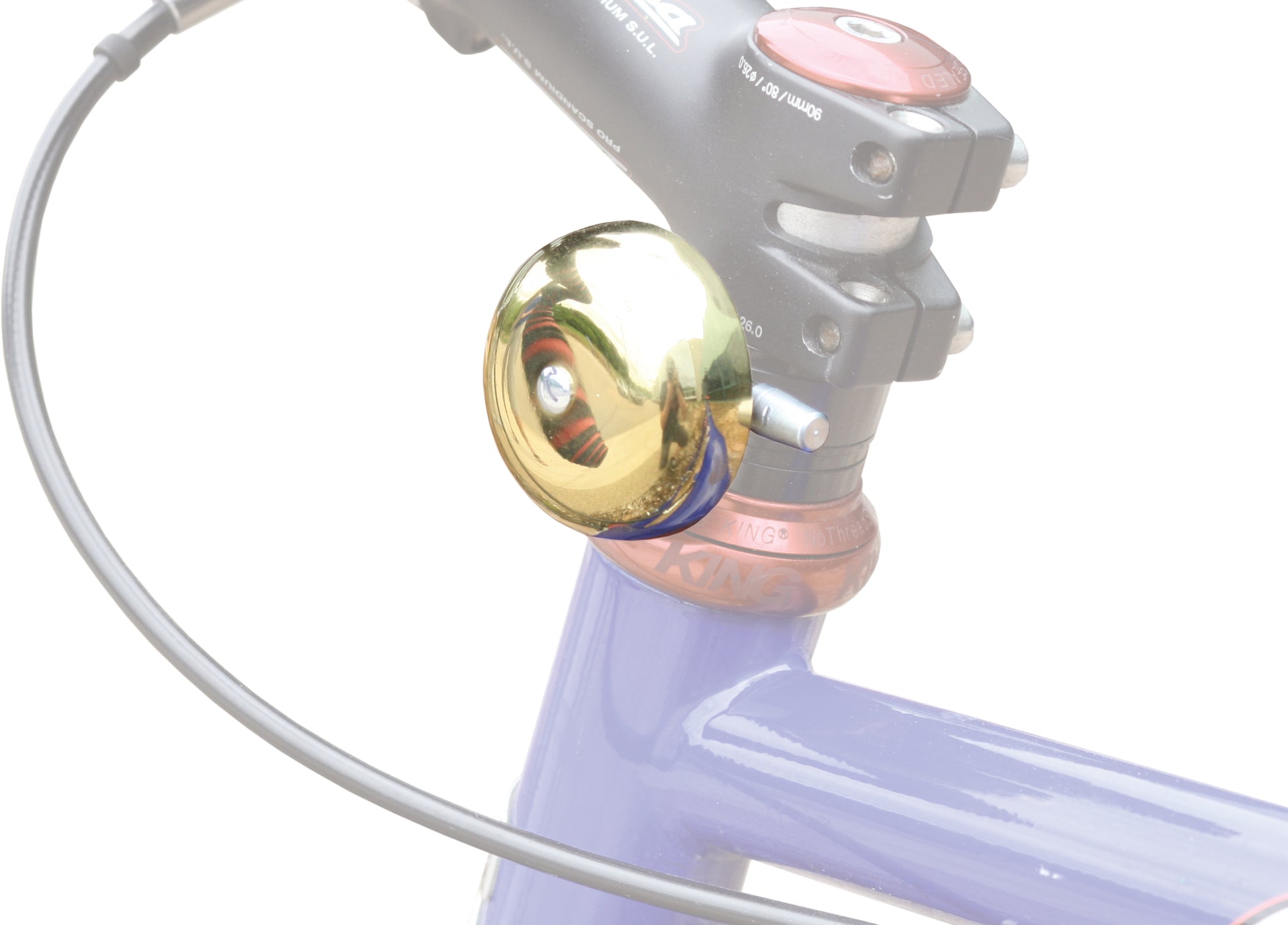 Dimension headset bell - Gold and black - shown mounted on a bike